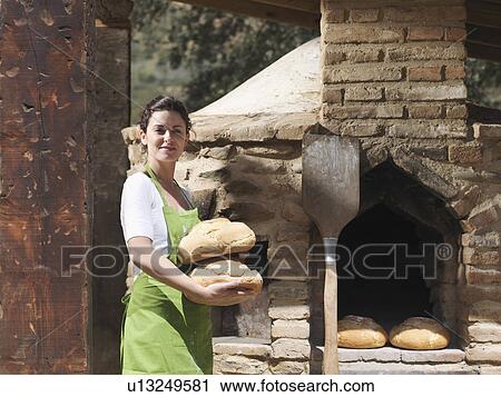 Woman holding freshly made bread loaves View Large Photo Image Stock Image - Woman holding freshly made bread loaves. Fotosearch