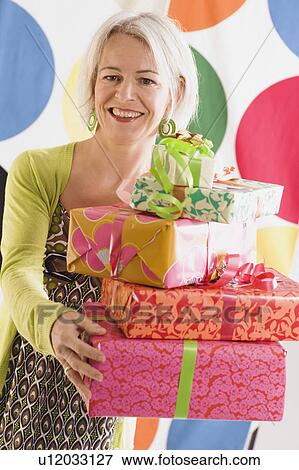 Stock Photo - Woman holding gifts. Fotosearch