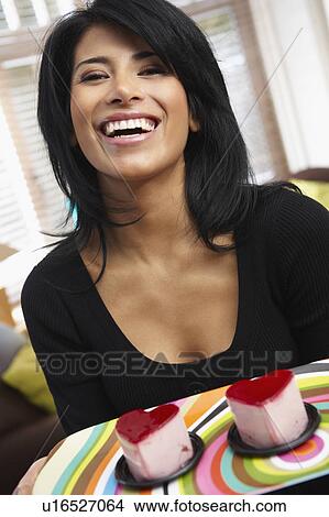 Woman holding two heart shaped cake View Large Photo Image Picture - Woman holding two heart shaped cake. Fotosearch