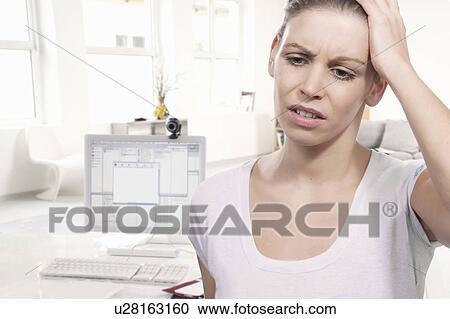 Stock Image - Woman in home office. Fotosearch
