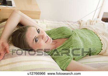 Stock Photograph - Woman in hotel room. Fotosearch