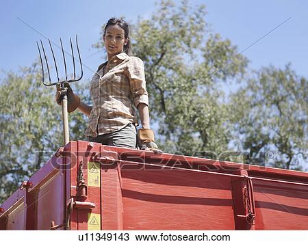 Woman in trailer with fork View Large Photo Image Stock Image - Woman in trailer with fork. Fotosearch