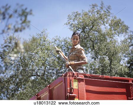 Woman in trailer with fork View Large Photo Image Stock Image - Woman in trailer with fork. Fotosearch