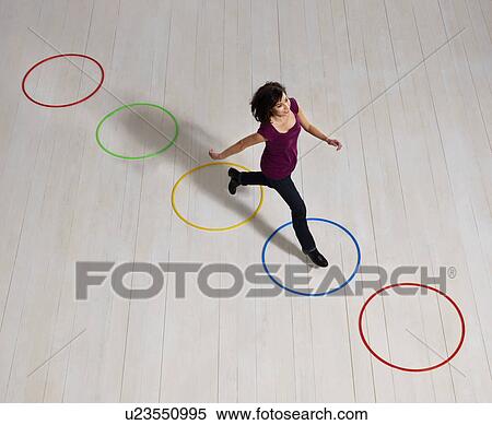 Woman jumping over circles View Large Photo Image Stock Photography - Woman jumping over circles. Fotosearch