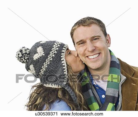 Stock Image - Woman kissing man on cheek. Fotosearch