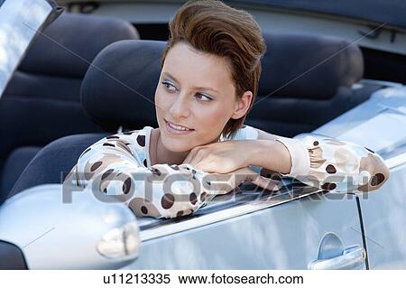 Stock Photography - Woman leaning out of car window. Fotosearch