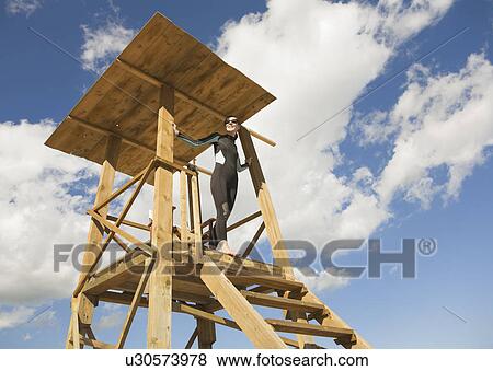 Woman lifeguard on lookout tower View Large Photo Image Stock Photo - Woman lifeguard on lookout tower. Fotosearch