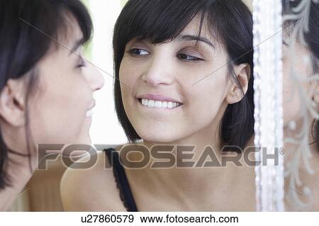 Woman looking in the mirror View Large Photo Image Stock Photo - Woman looking in the mirror. Fotosearch