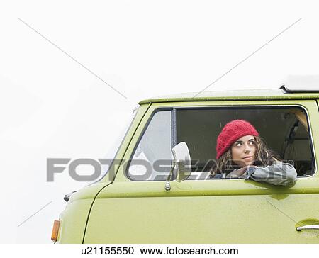 Woman looking out of camper van View Large Photo Image Stock Image - Woman looking out of camper van. Fotosearch