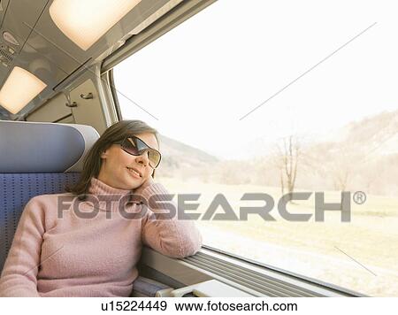 Woman looking out of window, on train View Large Photo Image Stock Photo - Woman looking out of window, on train. Fotosearch