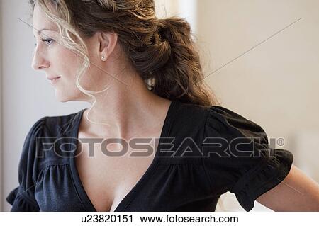 Stock Image - Woman looking out of window. Fotosearch