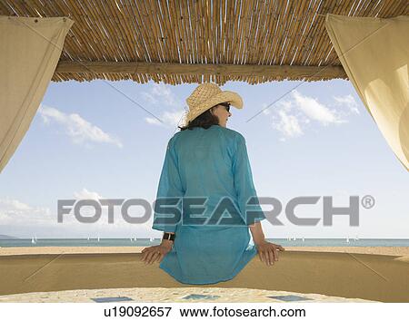 Stock Photo - Woman looking out to sea. Fotosearch