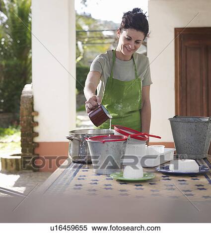 Stock Photography - Woman making goat cheese. Fotosearch