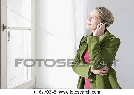 Woman on her mobile View Large Photo Image Stock Photo - Woman on her mobile. Fotosearch