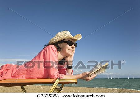 Stock Photo - Woman On Sun Lounger. Fotosearch