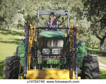 Woman on tractor View Large Photo Image Stock Photo - Woman on tractor. Fotosearch