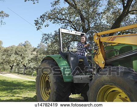 Woman on tractor View Large Photo Image Stock Photo - Woman on tractor. Fotosearch