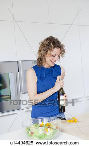 Woman opening bottle of wine View Large Photo Image Stock Photography - Woman opening bottle of wine. Fotosearch