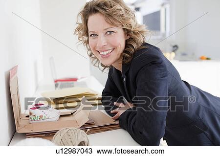 Woman packing baby shoes View Large Photo Image Stock Image - Woman packing baby shoes. Fotosearch