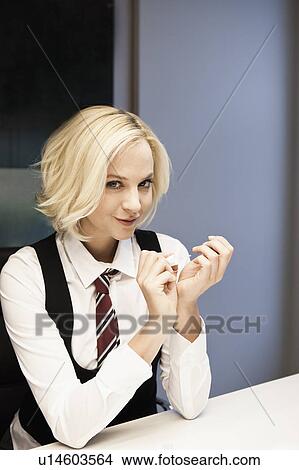 Picture - Woman polishing nails portrait. Fotosearch