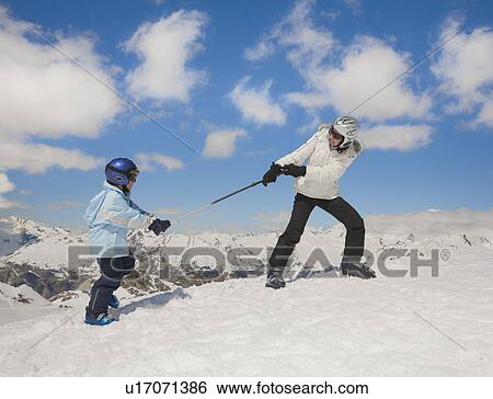 Woman pulling boy up snowy hill View Large Photo Image Stock Photograph - Woman pulling boy up snowy hill. Fotosearch