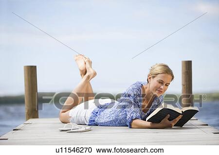 Woman reading a book View Large Photo Image Stock Image - Woman reading a book. Fotosearch