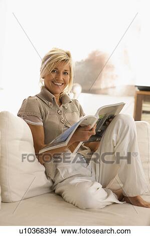 Picture - Woman reading a journal. Fotosearch
