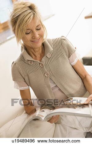 Stock Photograph - Woman reading a journal. Fotosearch