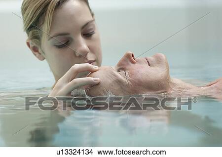 Picture - Woman receiving massage in pool. Fotosearch