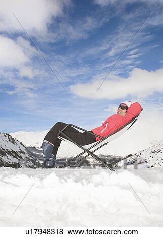Woman relaxing in snowy mountain scene View Large Photo Image Stock Photo - Woman relaxing in snowy mountain scene. Fotosearch
