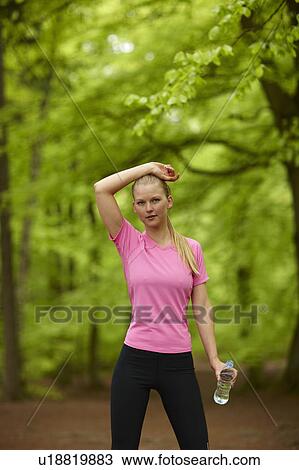 Woman running, standing still with water View Large Photo Image Stock Image - Woman running, standing still with water. Fotosearch