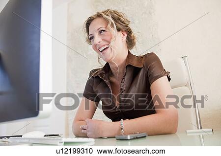 Woman sitting front of computer View Large Photo Image Stock Image - Woman sitting front of computer. Fotosearch