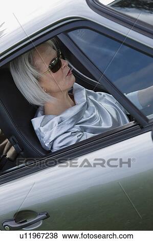 Woman sitting in car View Large Photo Image Stock Photo - Woman sitting in car. Fotosearch