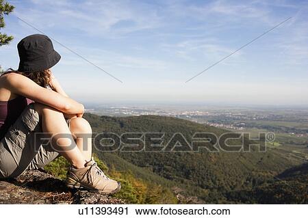 Woman sitting on mountain top View Large Photo Image Stock Image - Woman sitting on mountain top. Fotosearch