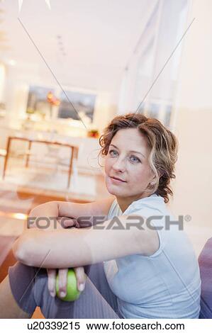 Woman sitting on window with an apple View Large Photo Image Stock Photography - Woman sitting on window with an apple. Fotosearch