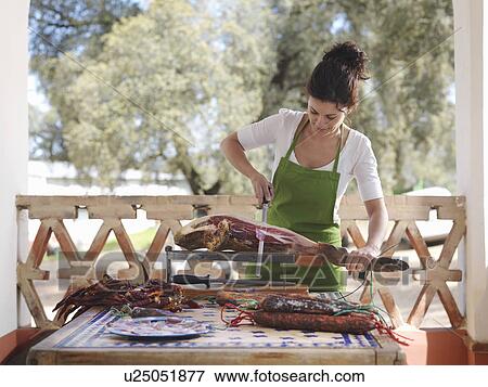 Woman slicing ham View Large Photo Image Stock Photo - Woman slicing ham. Fotosearch