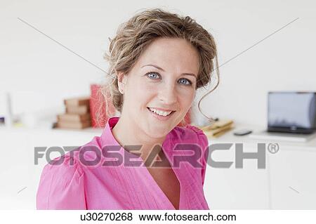 Woman smiling at her office View Large Photo Image Stock Photo - Woman smiling at her office. Fotosearch