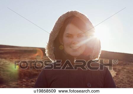Woman smiling in field View Large Photo Image Stock Photo - Woman smiling in field. Fotosearch