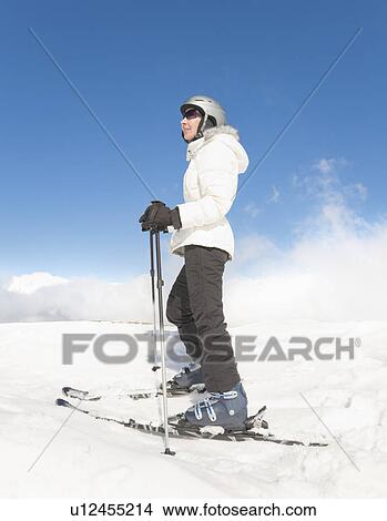 Woman Standing wearing Skis View Large Photo Image Picture - Woman Standing wearing Skis. Fotosearch