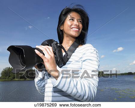 Woman taking pictures, smiling View Large Photo Image Stock Photo - Woman taking pictures, smiling. Fotosearch