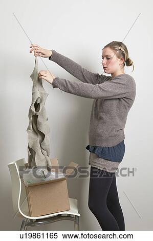 Stock Photography - Woman taking scarf out of box. Fotosearch