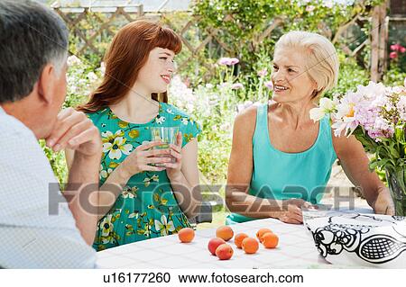 woman talks with mature couple in garden View Large Photo Image Stock Image - woman talks with mature couple in garden. Fotosearch