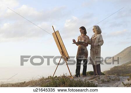Woman teaching young man how to paint View Large Photo Image Stock Photography - Woman teaching young man how to paint. Fotosearch