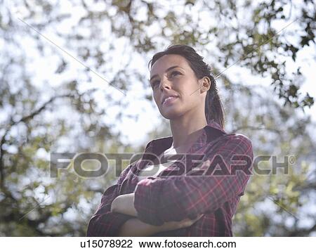 Stock Image - Woman thinking looking at horizon. Fotosearch