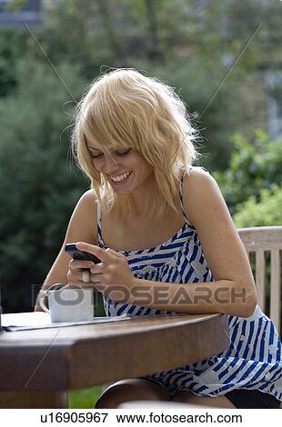 Stock Photo - Woman using cell phone. Fotosearch
