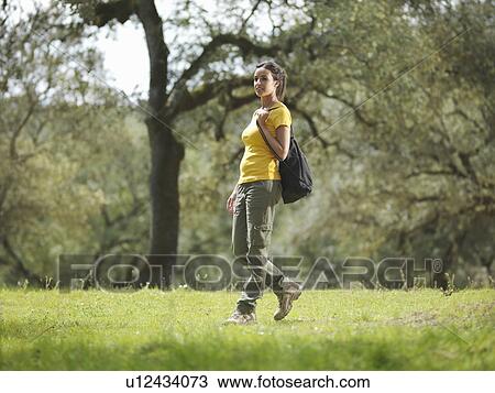 Woman walking in countryside View Large Photo Image Stock Image - Woman walking in countryside. Fotosearch
