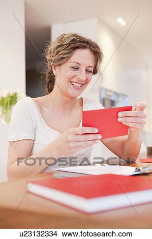 Picture - Woman with a red envelope. Fotosearch