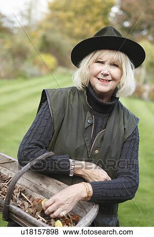 Woman with basket of wild mushrooms View Large Photo Image Stock Photo - Woman with basket of wild mushrooms. Fotosearch