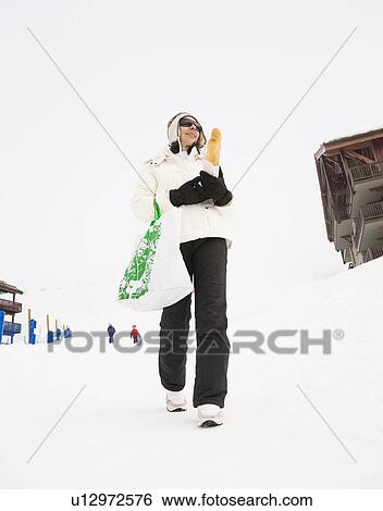 Woman with bread walking in snow View Large Photo Image Stock Photograph - Woman with bread walking in snow. Fotosearch