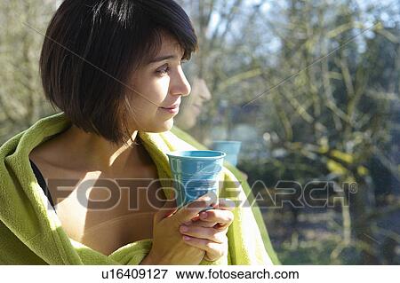 Woman with coffee, looking outside View Large Photo Image Stock Photo - Woman with coffee, looking outside. Fotosearch
